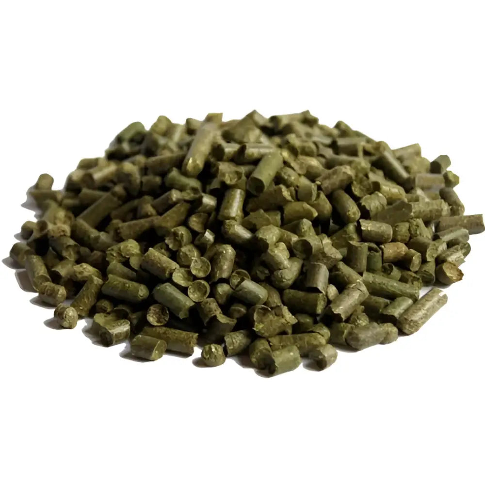 A pile of green cylindrical hop pellets from simple system horse feeds blue bag grass pellets for healthy nutrition