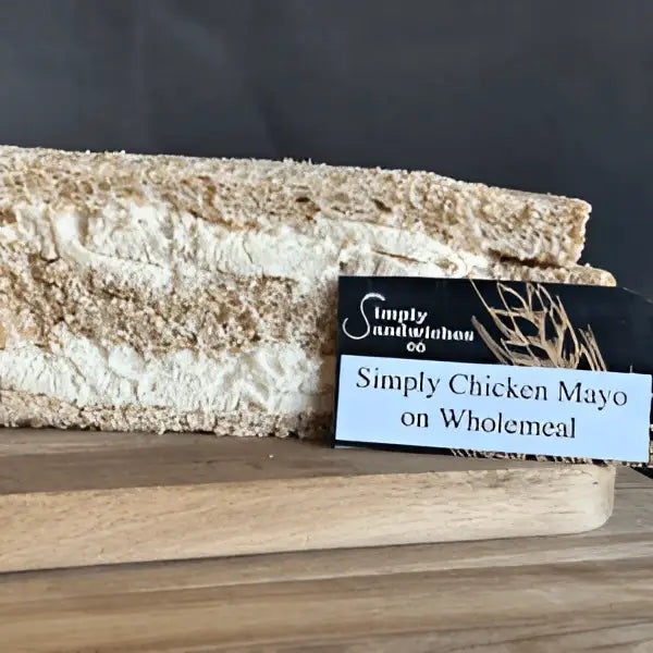 A simply sandwiches sandwich with wholemeal bread and chicken mayo on a wooden board without sugar coatings