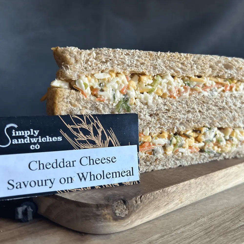 A triangular simply sandwiches made with wholemeal bread and creamy cheddar cheese filling perfect for snacks