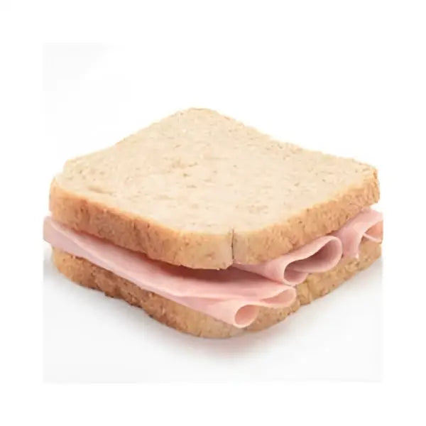 A simple simply sandwiches sandwich with two slices of light brown bread and thinly sliced pink ham layers