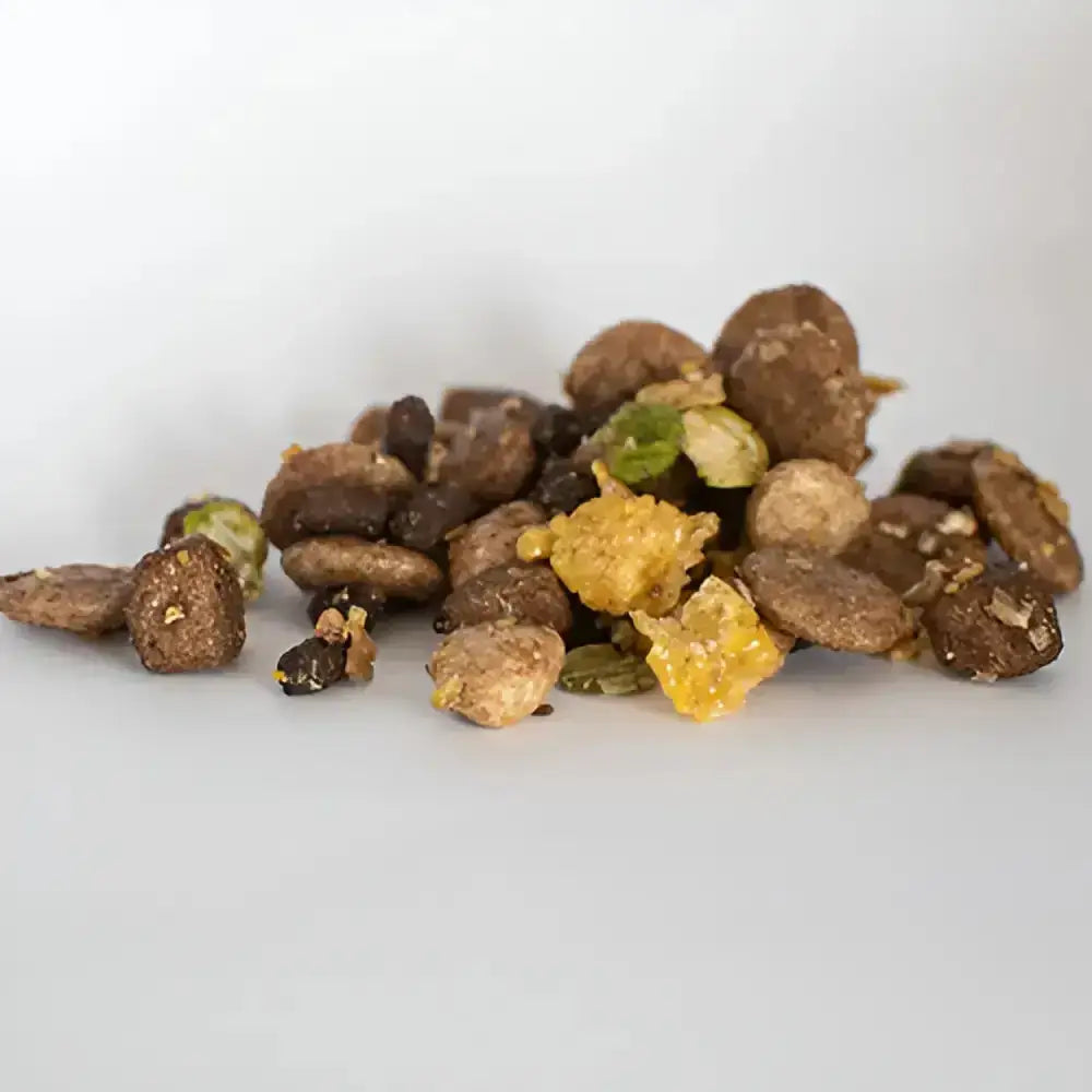 A pile of brown irregular skinners field trial muesli mix pet treats with green and yellow pieces mixed in