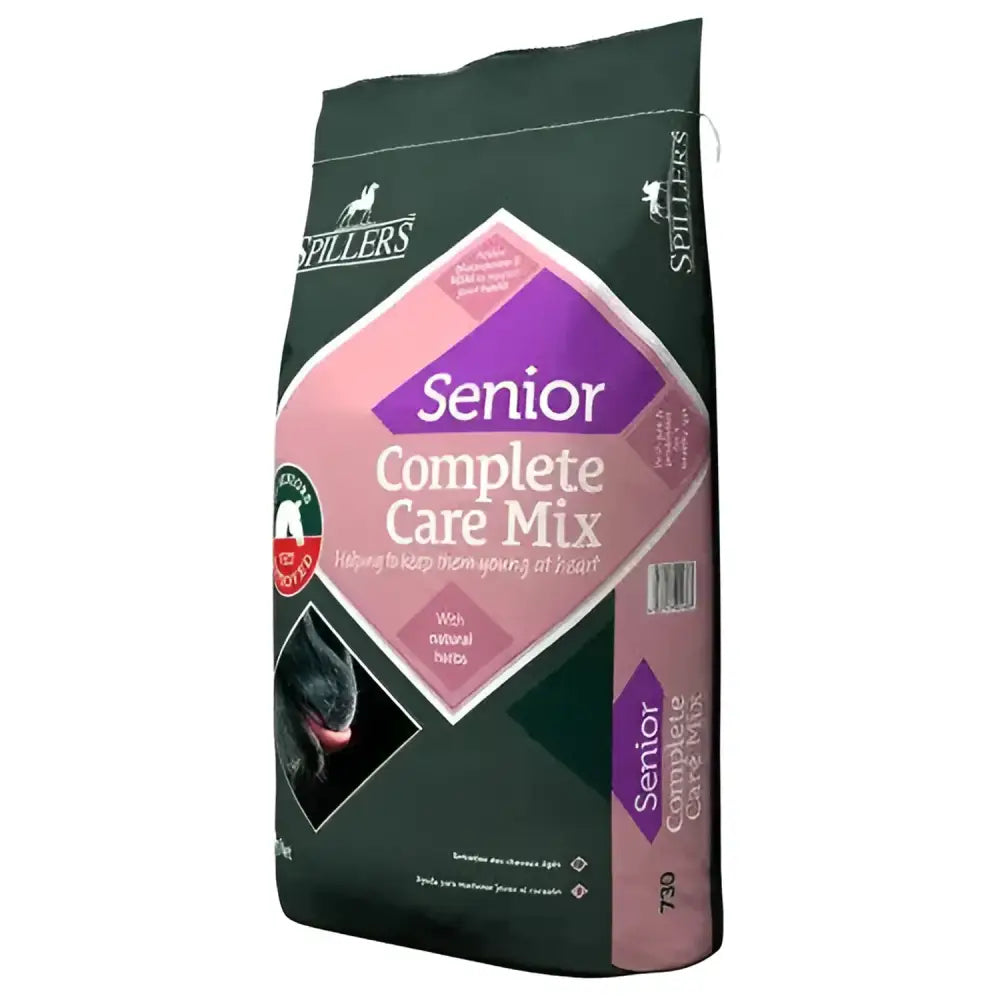 Dark green bag of spillers senior care mix dog food with pink purple label showing black dog face for complete nutritional care including digestive health