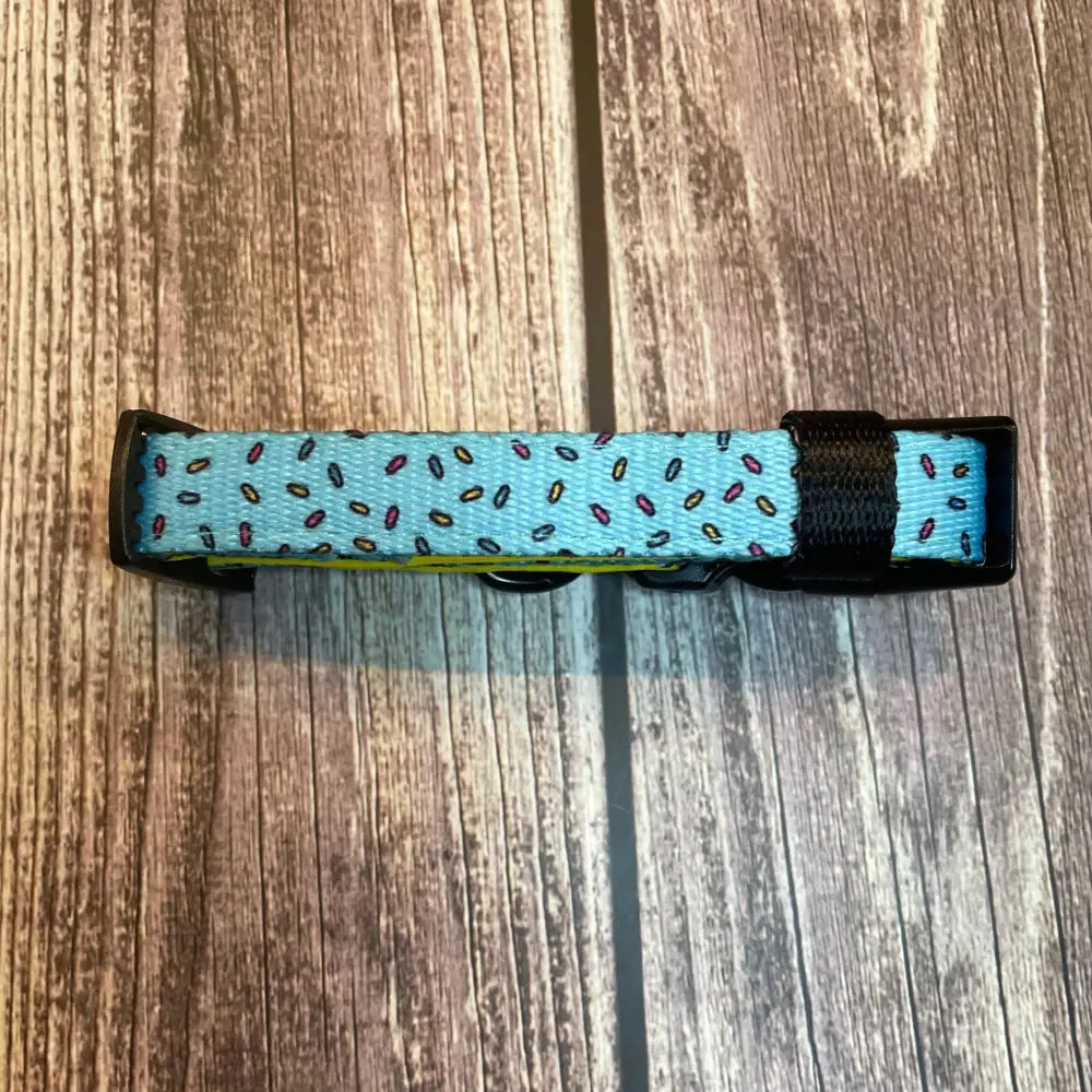 A light blue days collar with playful sprinkles pattern and black plastic hardware perfect for everyday wear