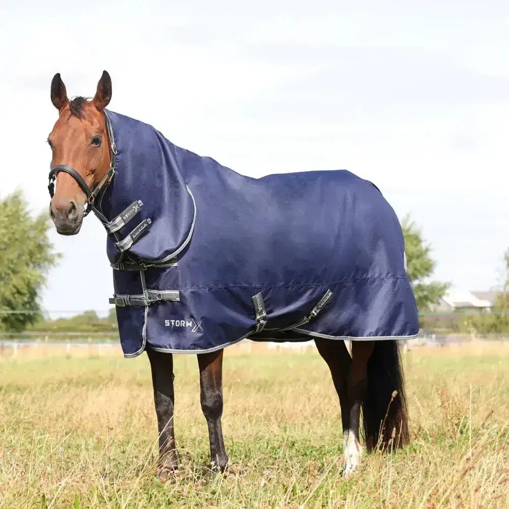 Navy blue stormx empra combi turnout rug with reflective trim and adjustable straps for horses in storm conditions