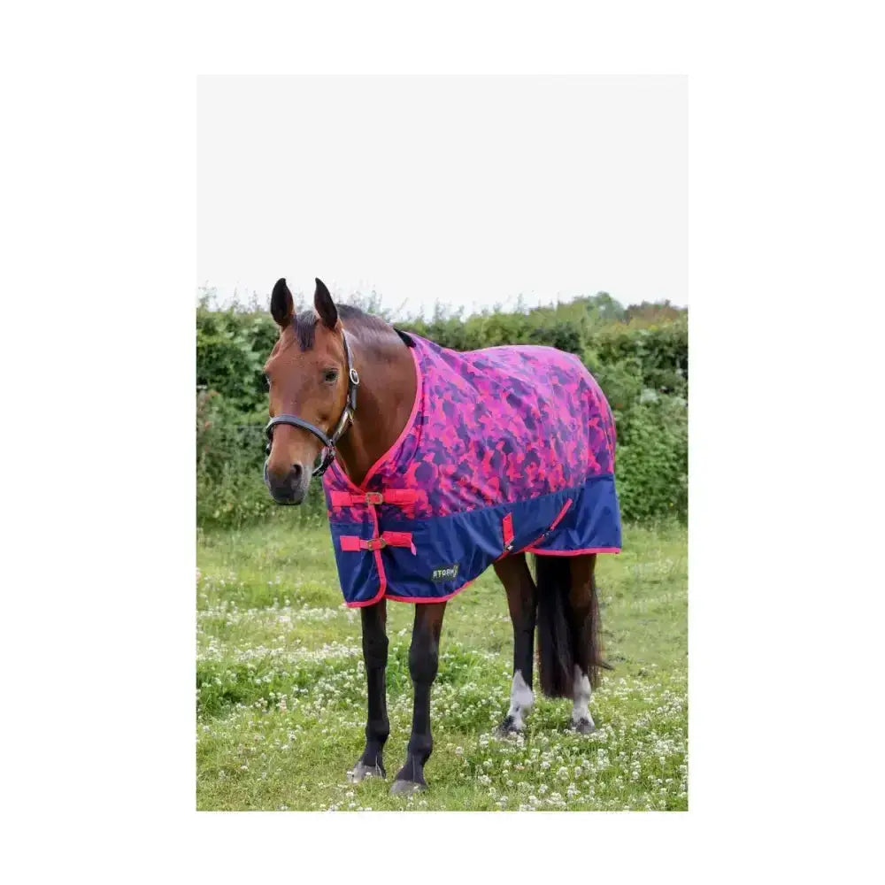 A vibrant pink and navy blue stormx original dynaforce 100g turnout rug with floral pattern and adjustable straps