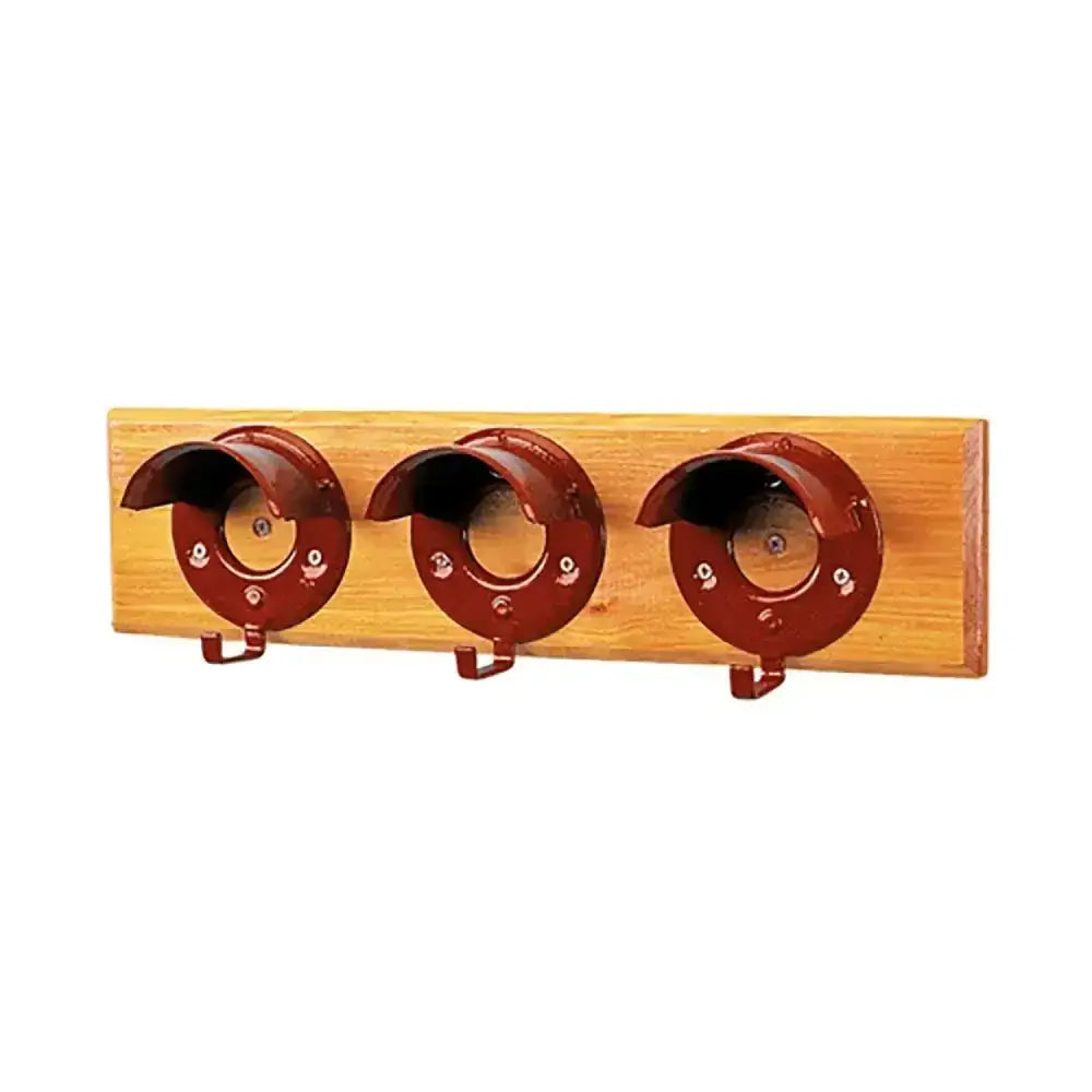 Red metal hat hooks on light wood plank of stubbs bridle rack set board s203 with specially designed round cowl