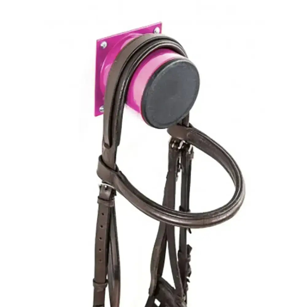 Brown leather stubbs bridle stub s2075 mounted on vibrant pink wall rack by europe’s leading bloodstock auctioneers
