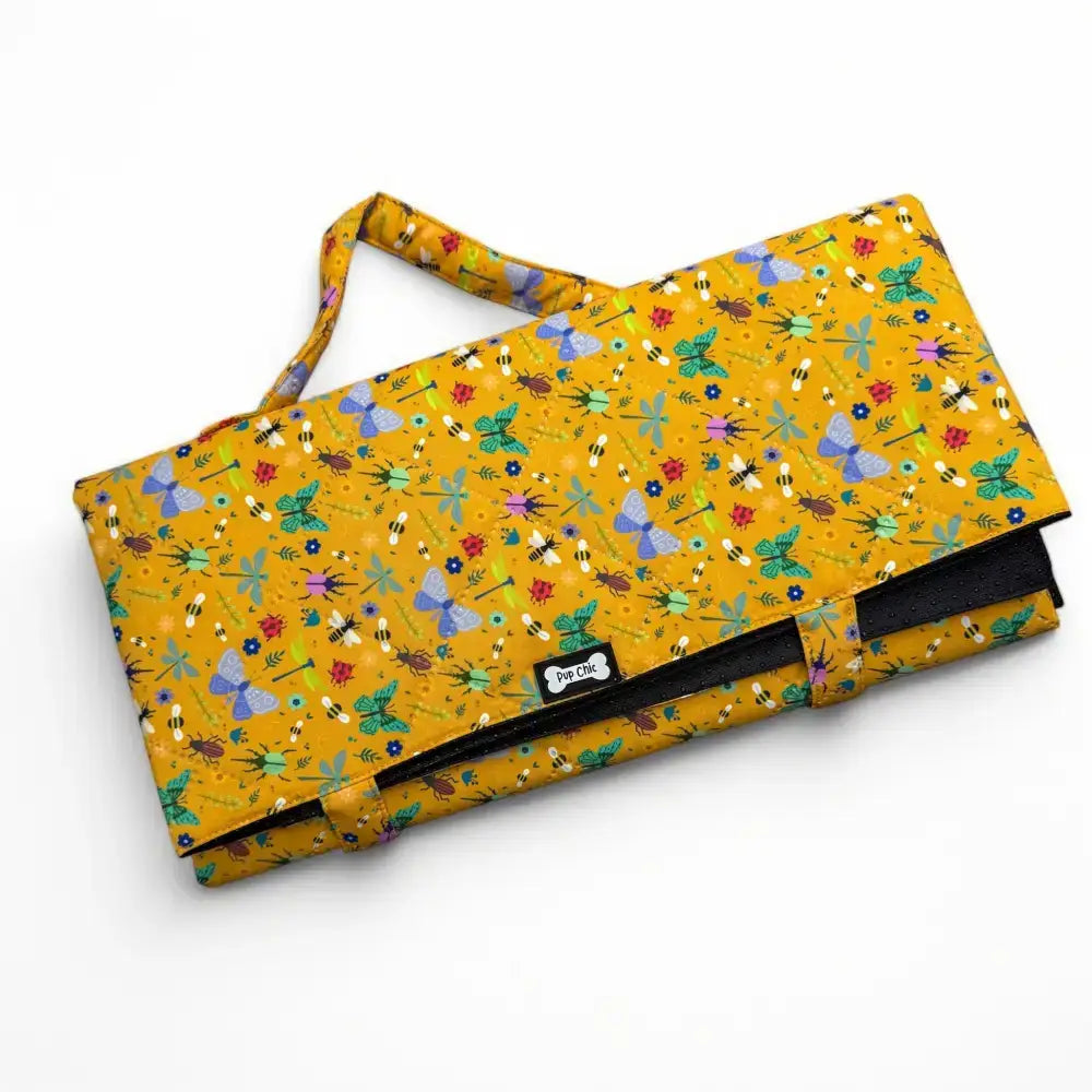 A vibrant yellow summer buzzin dog settle mat with bees butterflies and flowers lightweight waterproof mat
