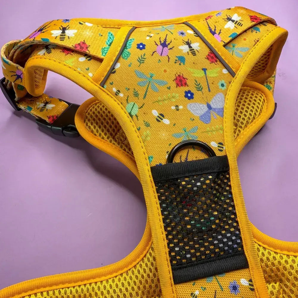 Bright yellow insect print tactical dog harness with bees and flowers on woven fabric for easy step-in use