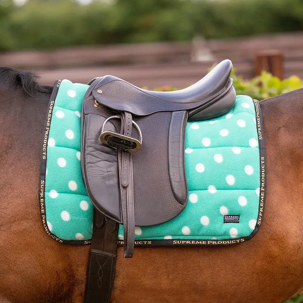 Teal fleece saddle pad with white dots black trim branded supreme products dotty perfect for riding comfort