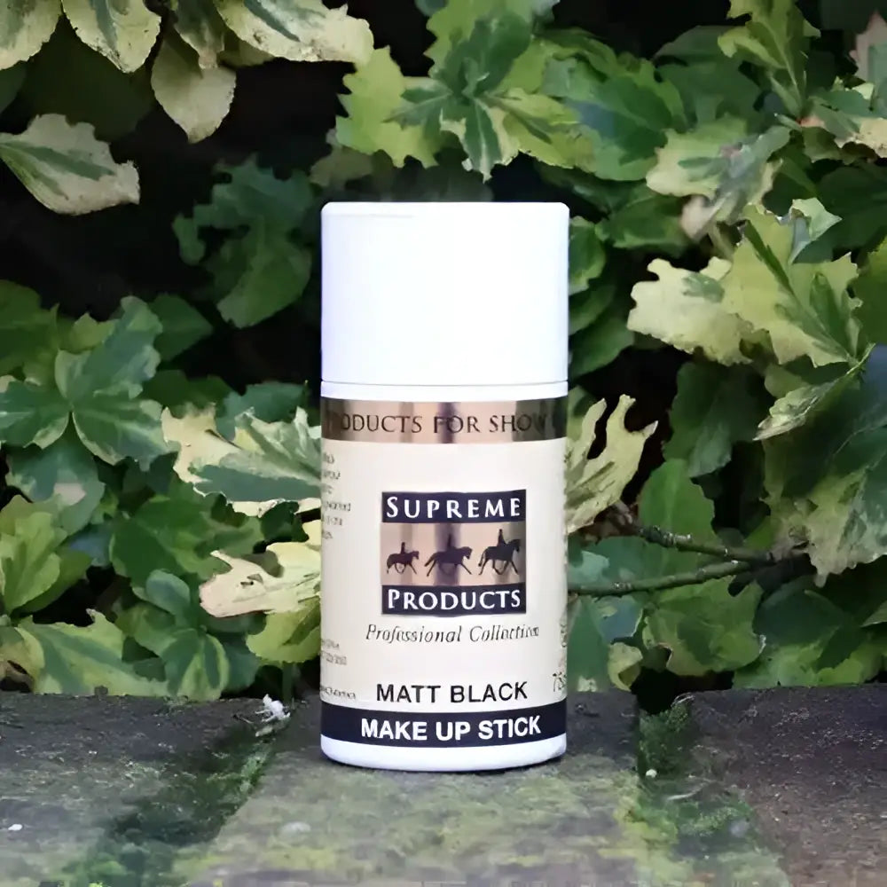 A matte black supreme products matt make up stick in a white container with horse silhouettes for horse owners