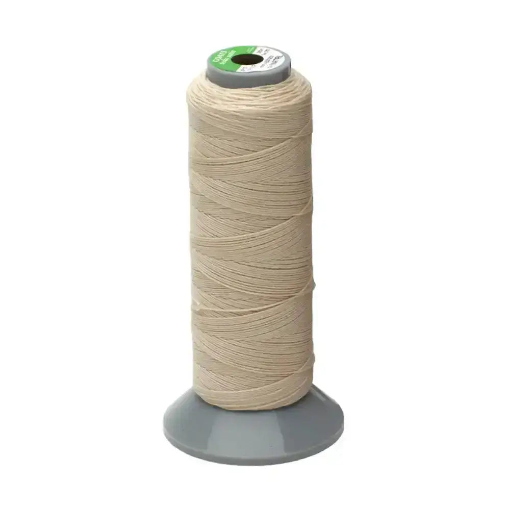 A spool of beige strong plaiting thread from supreme products plaiting wound on a gray core with a green and white label