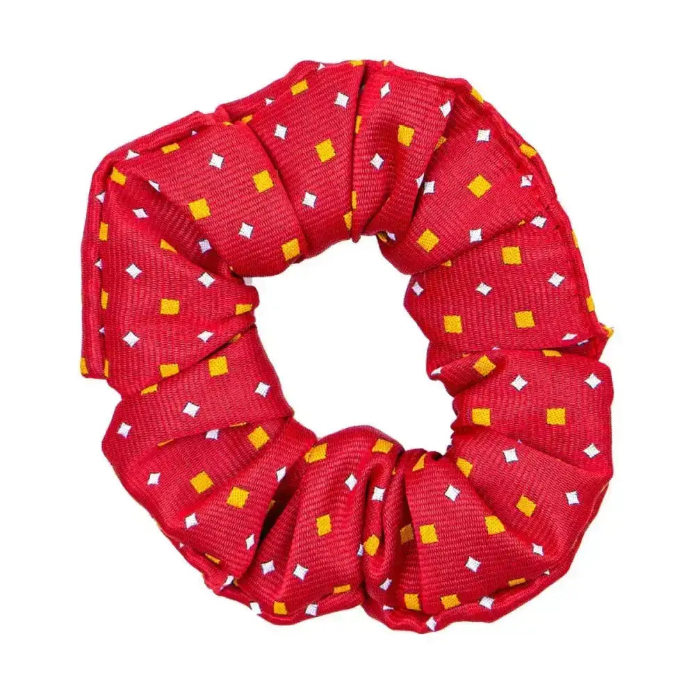 A vibrant red Supreme Products Show scrunchie with yellow and white diamond patterns adds the final touch to ring attire