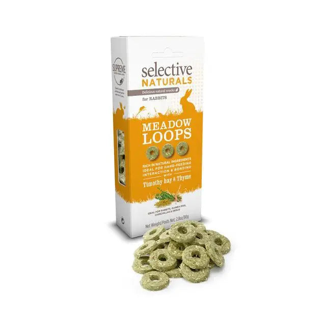 Green ring-shaped rabbit treats in a white and orange box labeled selective naturals meadow loops4x80g by supreme selective nat