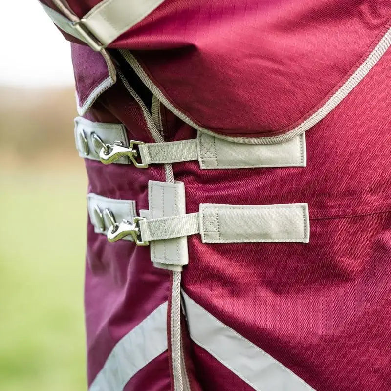 Maroon burgundy turnout rug with beige straps and silver buckles featuring detachable neck turnout design