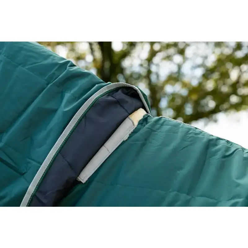 Teal quilted sleeping bag with navy blue interior and gray zipper trim shown with detachable neck hunter stable rug