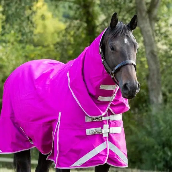 A vibrant magenta swish 200g detachable neck turnout rug with white reflective stripes and silver buckles for warmth and visibility