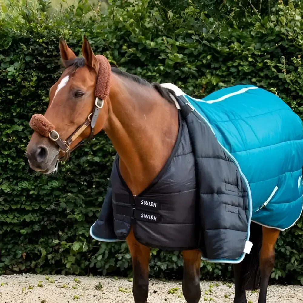 A black and teal 300g horse rug liner with white trim and swish branding ideal for stable rugs and rug liners