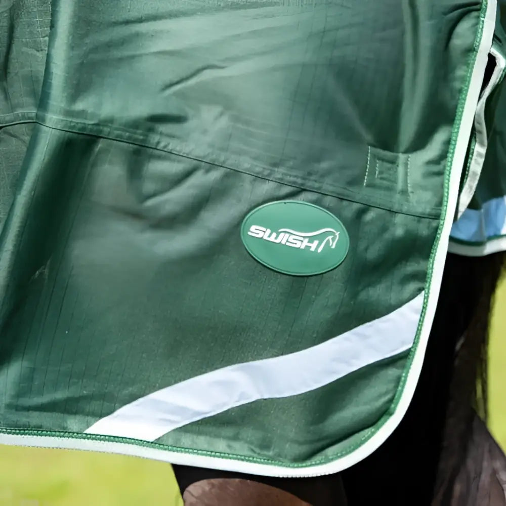 Green swish 50g detachable neck turnout rug with white diagonal stripe and stitched edge in hunter green