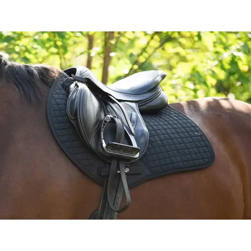 Black leather contact gp saddle with metal stirrups resting on a horse with quilted saddle pad orange for high wither