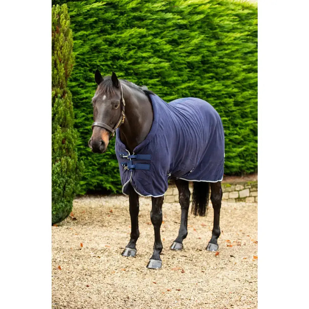 Navy swish fleece horse rug with breathable cross surcingles white trim and silver piping for cozy warmth