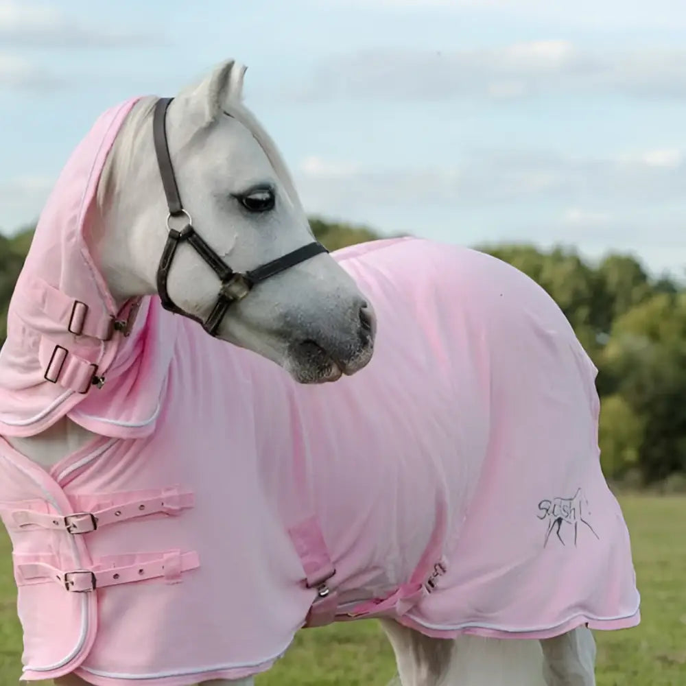 Baby pink fleece rug with neck cover featuring black buckles cross surcingles and subtle silver piping logo