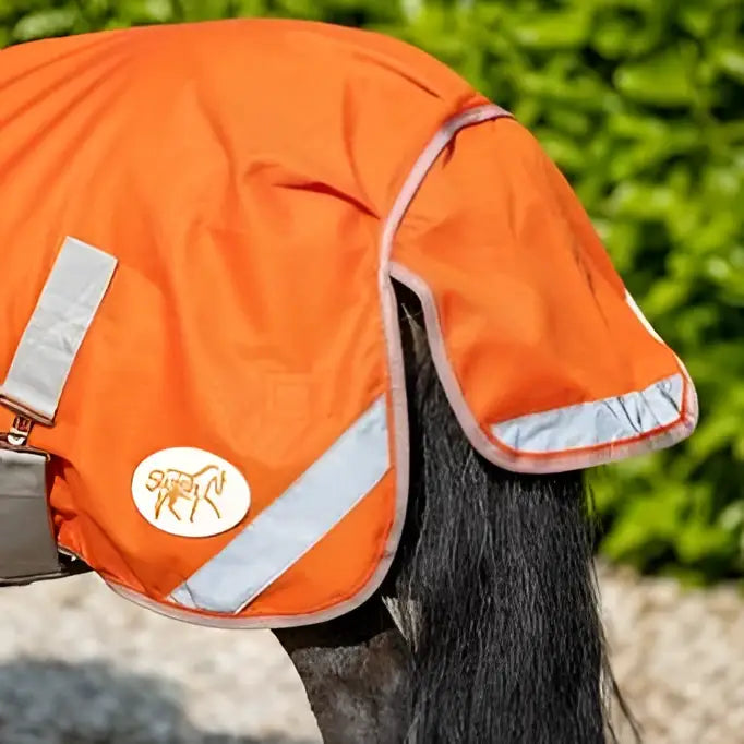 Bright orange swish mini 50g turnout rug with reflective strips white logo and cross surcingles for safety and comfort