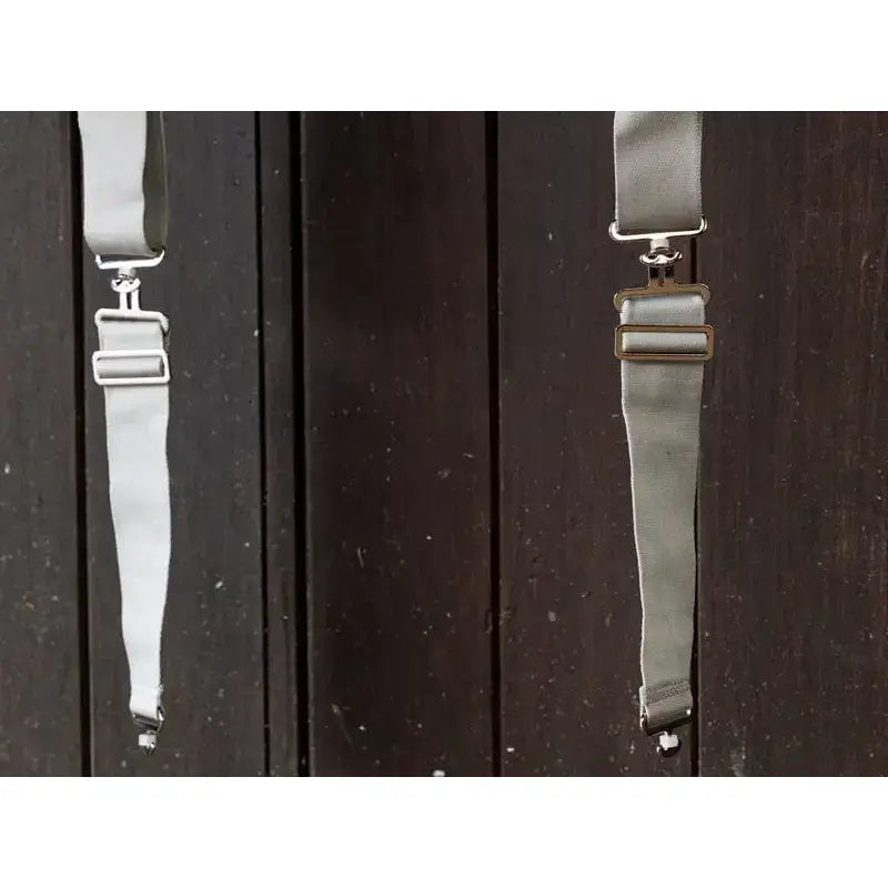 Gray fabric surcingle extenders with silver clasps and adjustable buckles perfect for equestrian horse gear adjustments
