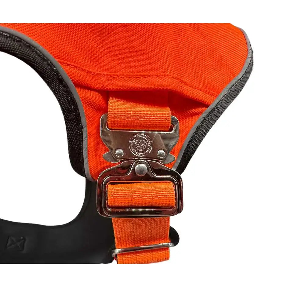 Bright orange ultimate btactical harness dog harness with black trim silver buckle and hidden tracker pocket