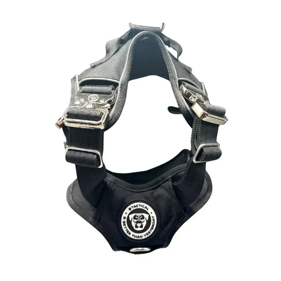 Black tactical dog harness with silver buckles and logo patch featuring body support and hidden tracker pocket