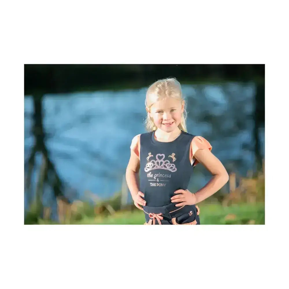 Navy t-shirt features pink ruffled shoulders and a crown graphic with the text the princess and the pony pony loving princess tee