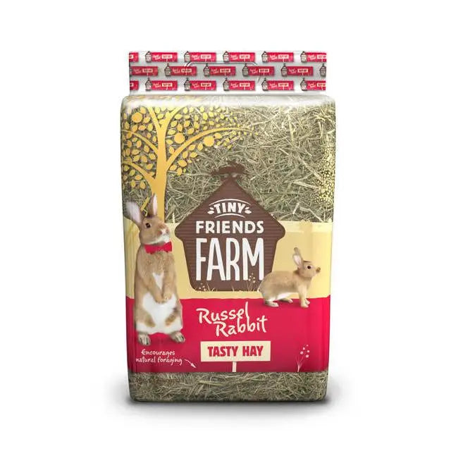 A 2kg package of tiny friends farm russel rabbit hay with colorful label featuring cartoon rabbits and tree design