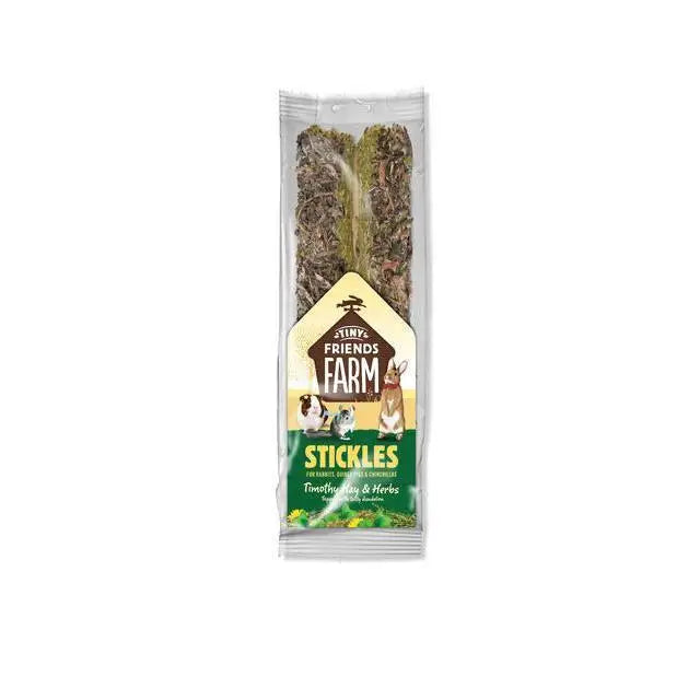 A package of tiny friends farm stickles tim hay8x100g with two dried timothy hay treats and a green beige label