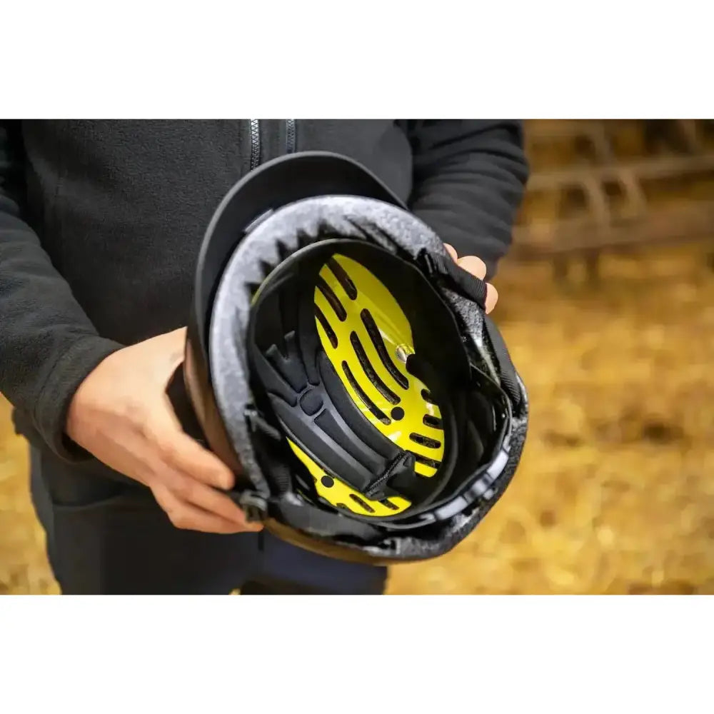 Black uvex exxential iii mips riding helmet with bright yellow interior lining and black padded straps for safety
