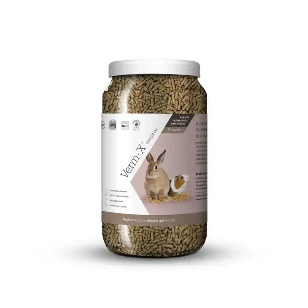 A clear plastic jar with white lid contains brown verm-x original nuggets for rabbits guinea pigs to control intestinal hygiene