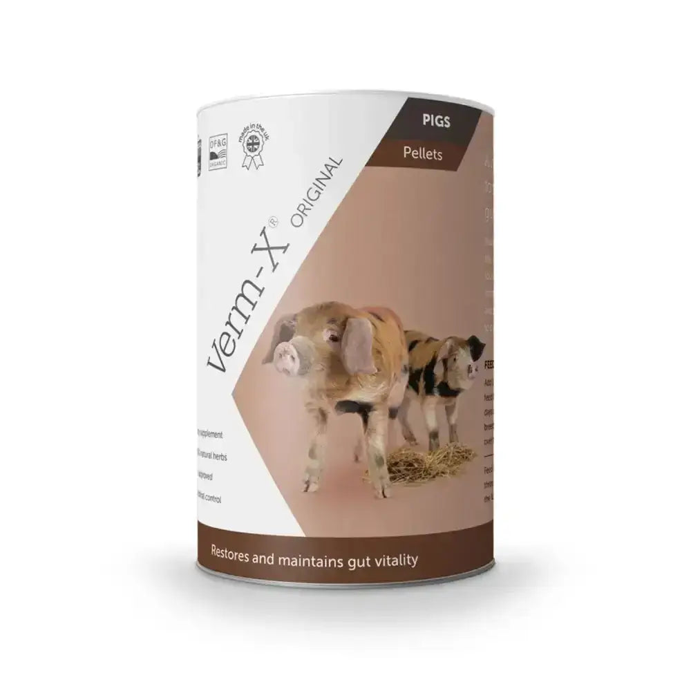 A cylindrical container of verm-x original pellets with a white and brown label showing pigs for pig supplements controls intestinal hygiene