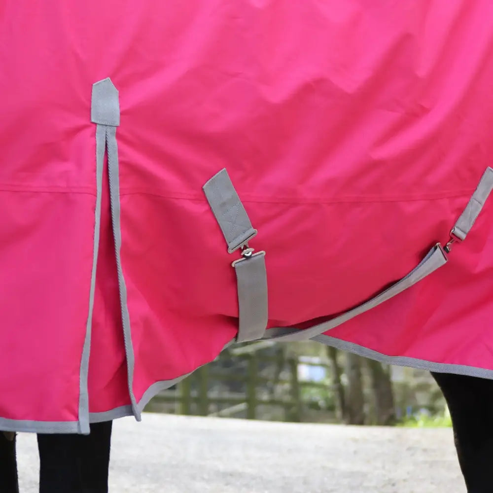 Bright pink whitaker 0g standard turnout rug with gray reflective trim and adjustable straps perfect for all weathers