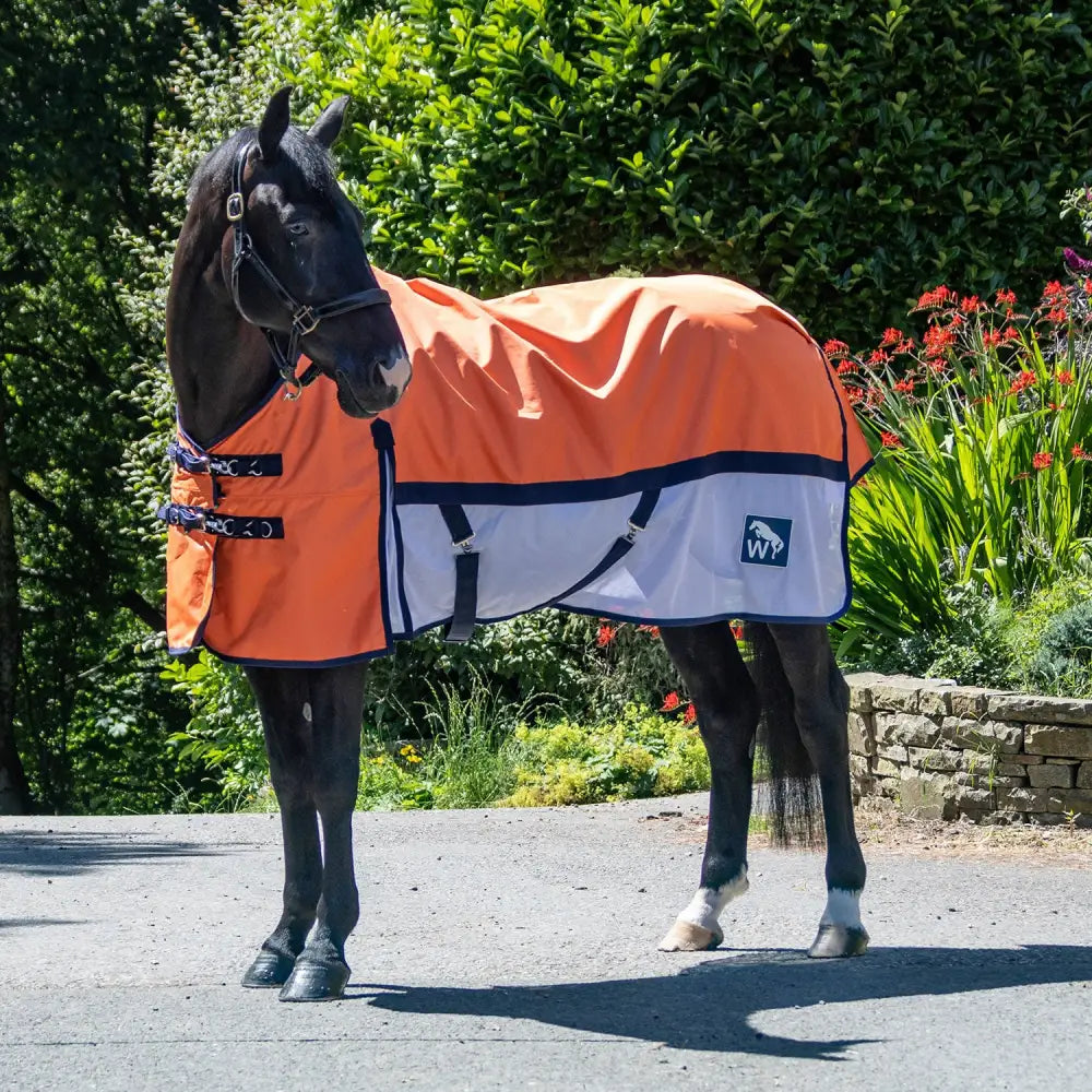 Bright orange and white whr28 w-horse airflo turnout rug with navy trim mesh skirt and branded logo patch on side