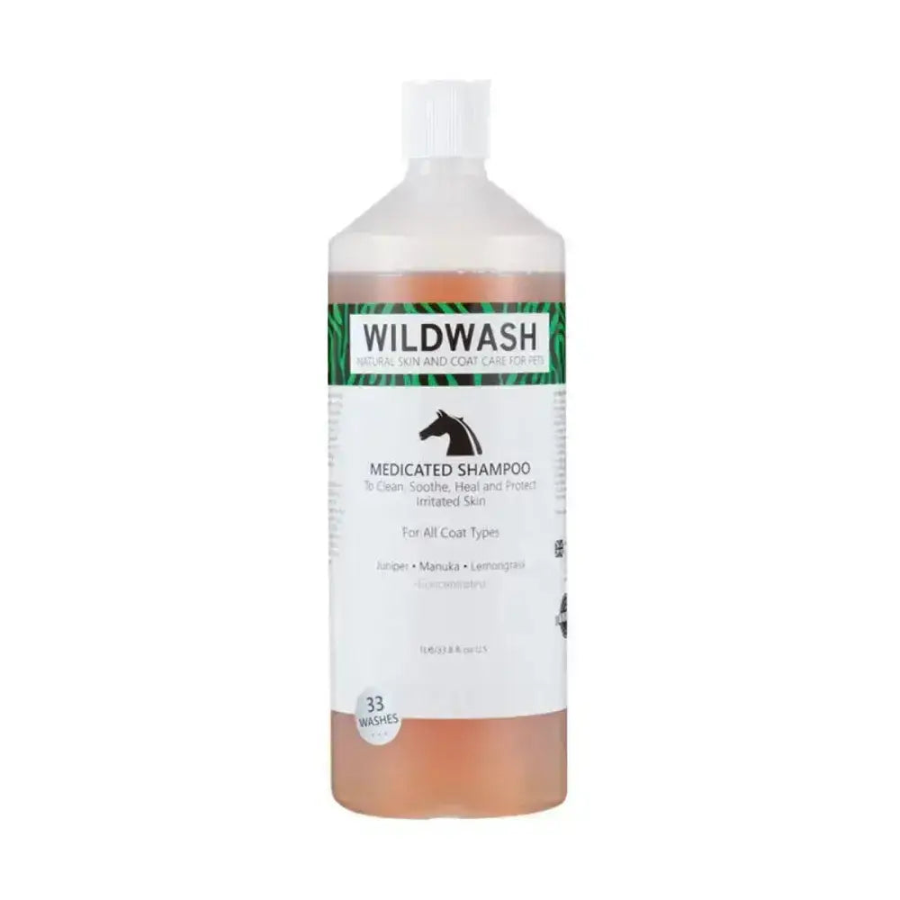 A clear plastic bottle of wildwash horse shampoo medicated with white cap and amber liquid inside