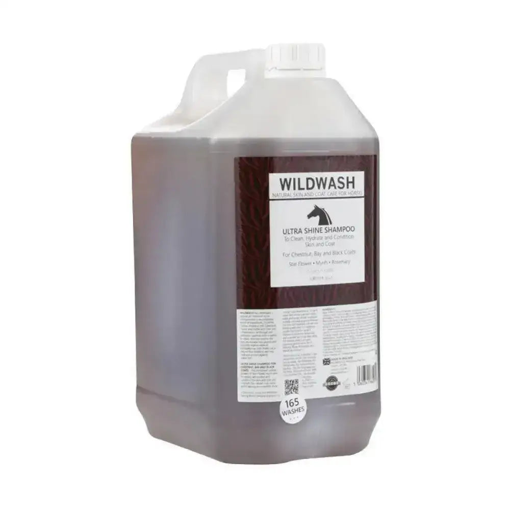 A translucent brown plastic jug with a white cap and handle labeled wildwash horse shampoo ultra shine shampoo for natural coat colour