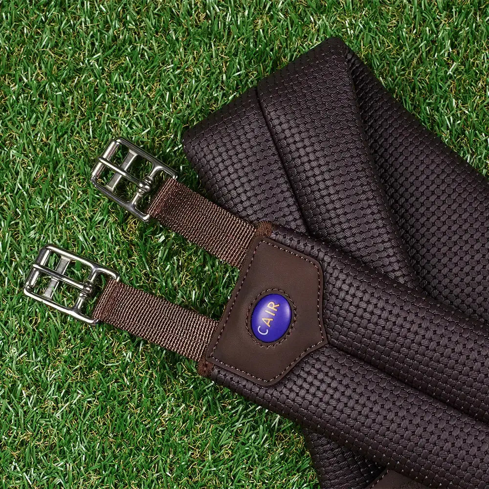 Brown woven leather wintec miracle girth short with silver buckles and purple logo patch for scientifically proven horse comfort
