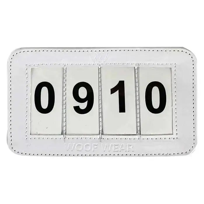 White leather framed woof wear dressage number holder flip calendar showing digit dressage number 0910 in black
