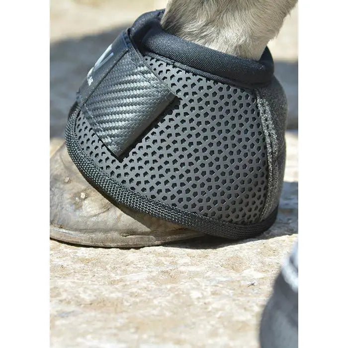 Black perforated woof wear ivent overreach boot with carbon fiber panel designed as a turn overreach boot