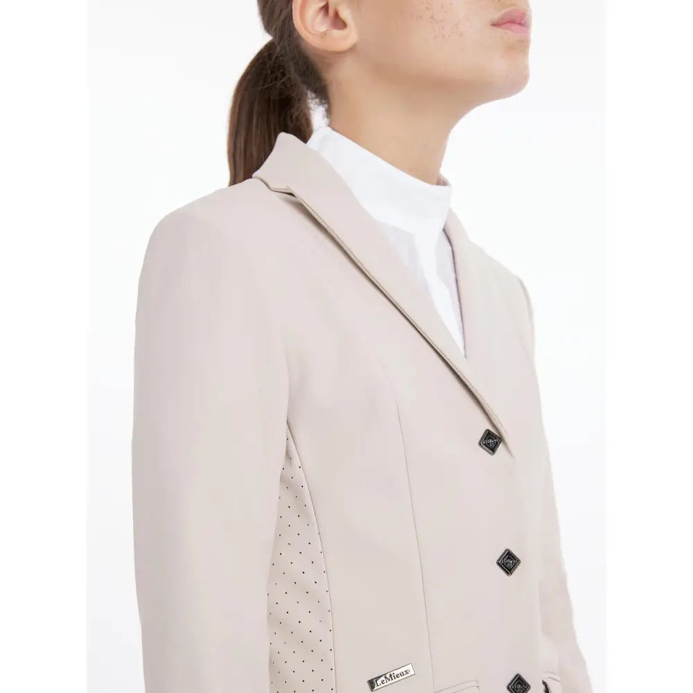 Beige lemieux young rider kennedy equestrian show jacket with black diamond buttons and subtle polka-dot side panel
