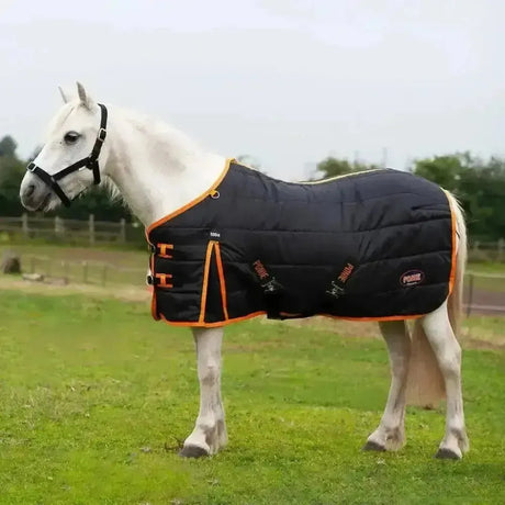 Black quilted horse stable rug with orange trim and adjustable straps featuring small side logo in horse stable rugs collection