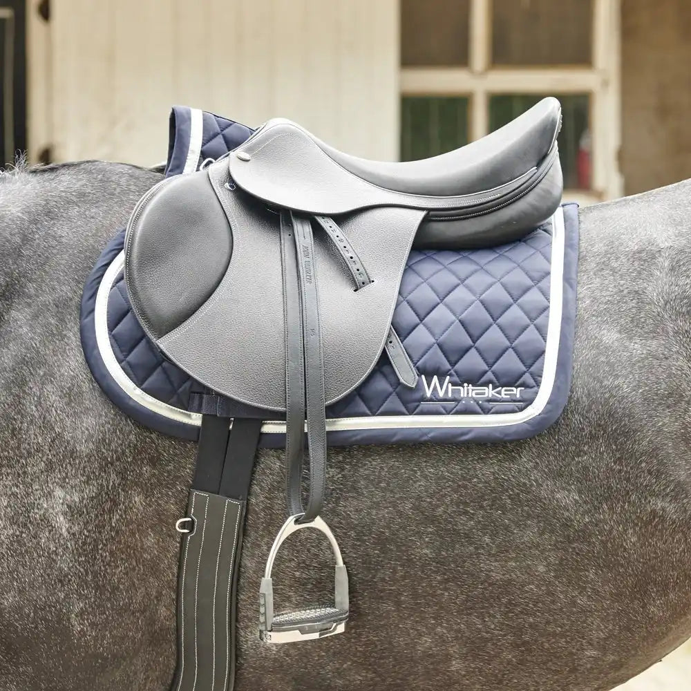 Gray leather english saddle with quilted navy blue whitaker pad from john whitaker horse tack collection