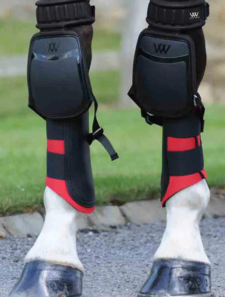 Horse leg protectors with black and red padding for knee & hock protection in equestrian gear.