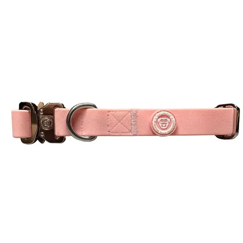 A sleek pastel pink pvc btactical dog collar with leather texture, metal buckle, and circular brand emblem