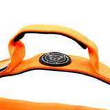 Bright orange nylon btactical dog harness with black trim and circular gray logo patch in citrus orange color