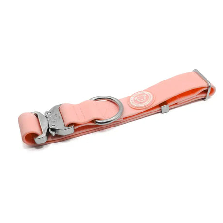 A sleek pastel pink 4cm pvc btactical dog collar with a sturdy silver metal buckle and d-ring for durability